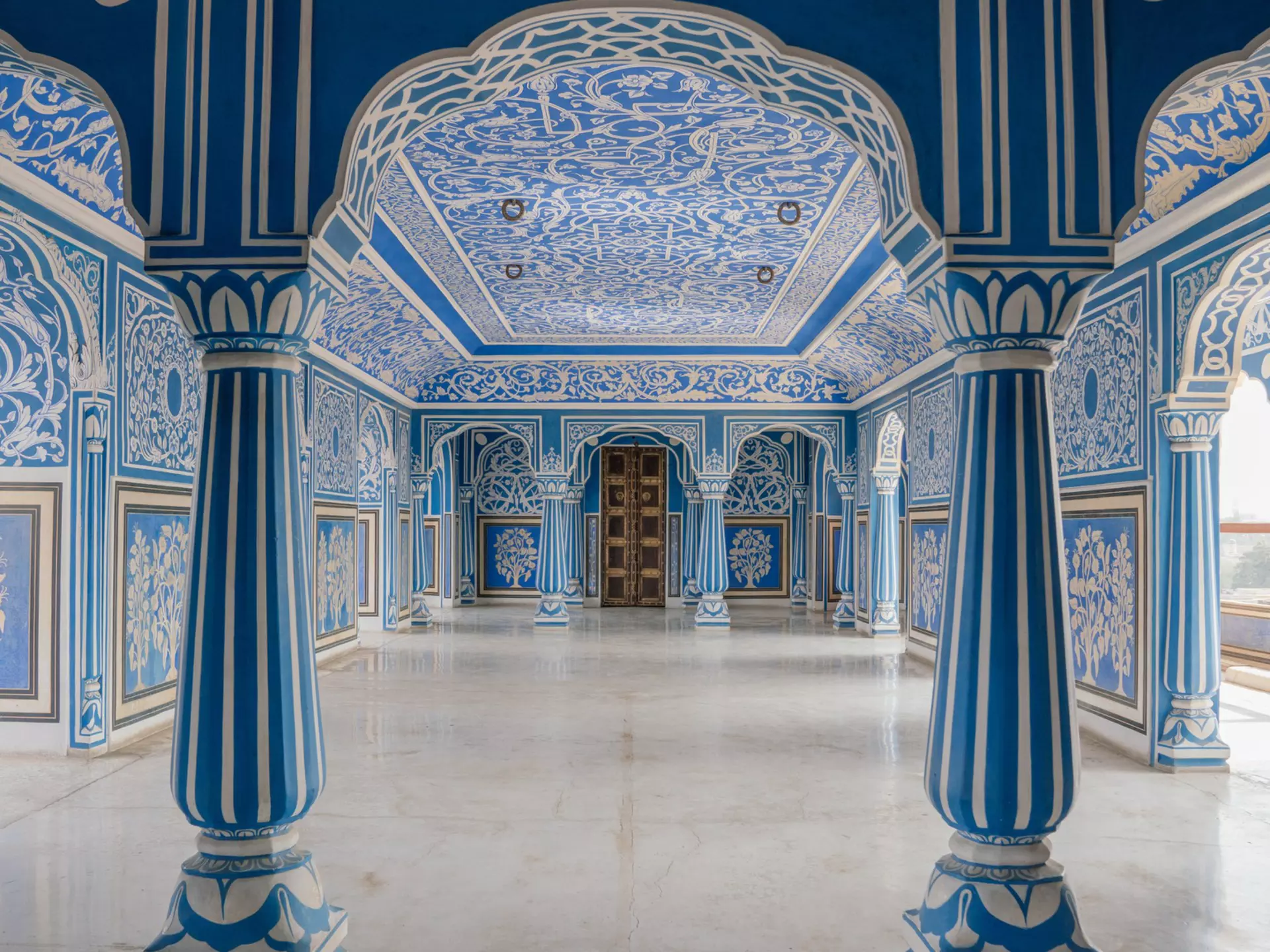 Ornate blue and white hand-painted hall inside a Jaipur palace