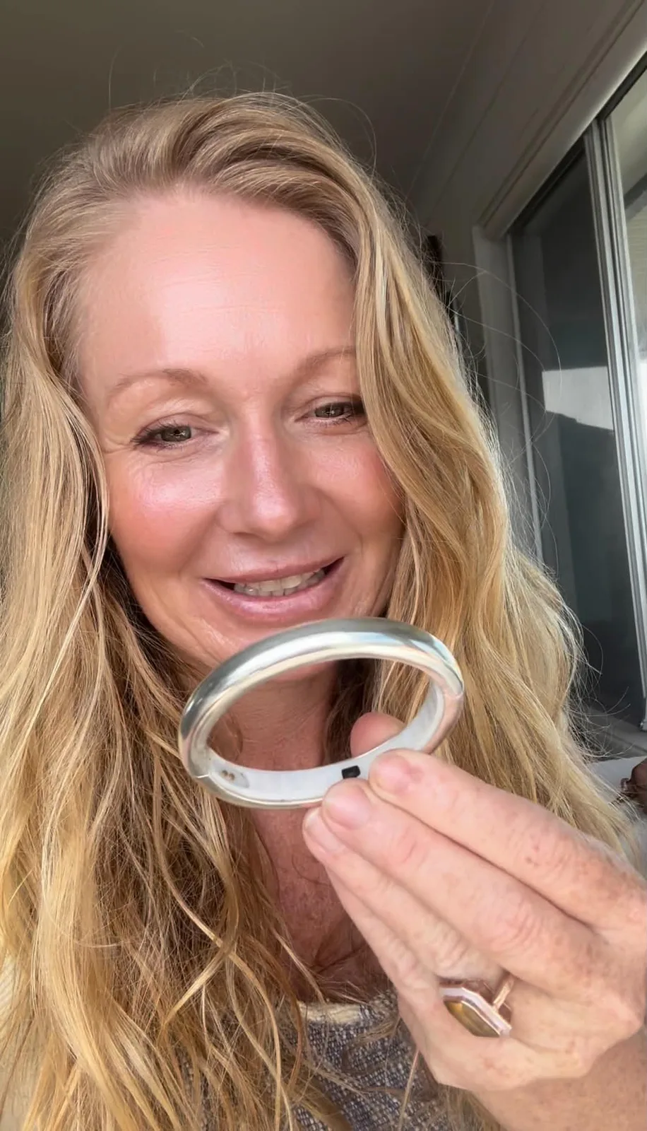 Kasey, founder of Halo by Halotech, holding a Halo smart jewellery piece